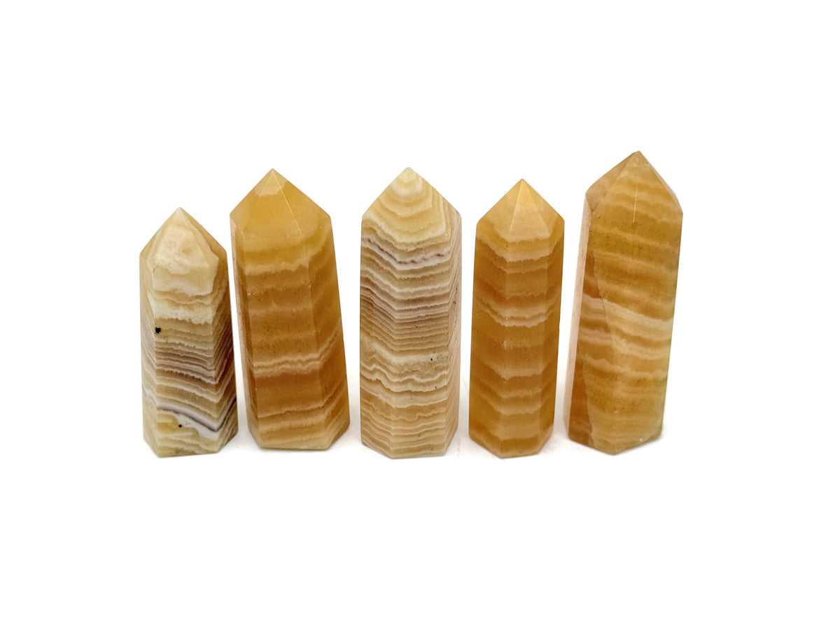 Yellow Calcite obelisk tower crystal from GemstoneGO, showing a vibrant yellow pointed gemstone with natural stone textures.