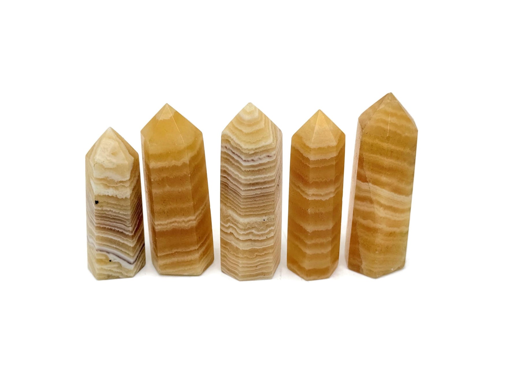 Yellow Calcite obelisk tower crystal from GemstoneGO, showing a vibrant yellow pointed gemstone with natural stone textures.