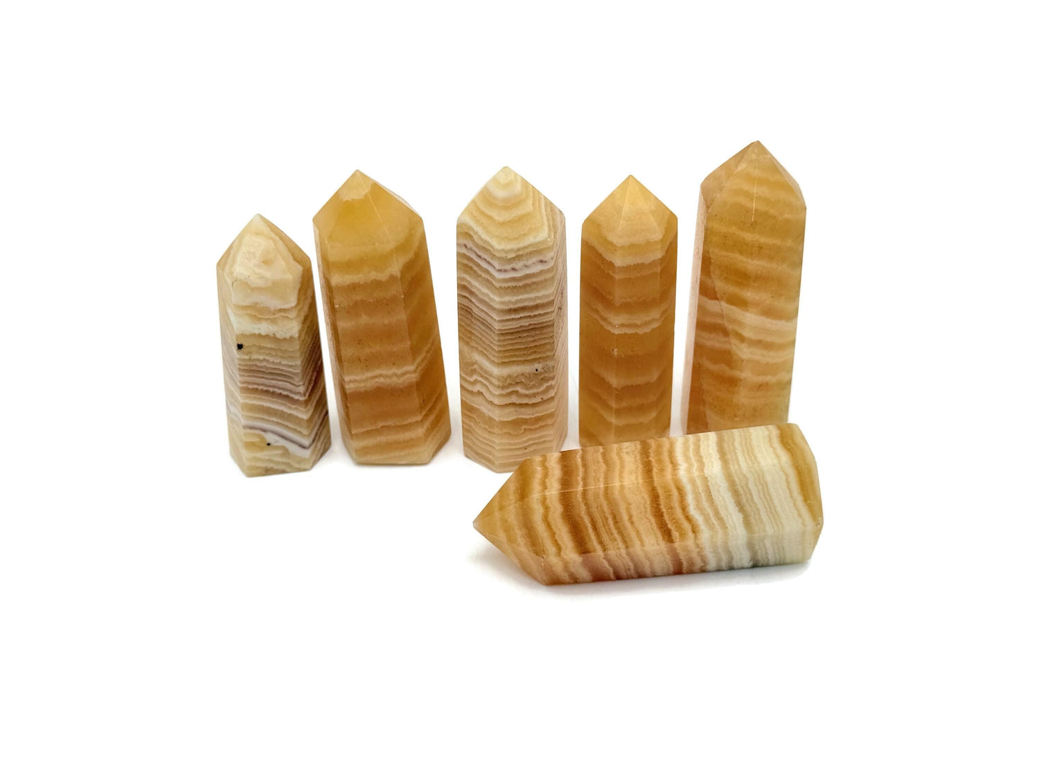 Yellow Calcite obelisk crystal tower with natural mineral textures and vibrant yellow color, showcasing a polished gemstone sculpture.