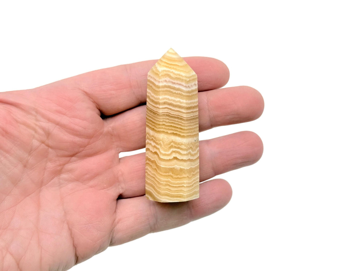 Yellow Calcite obelisk tower crystal from GemstoneGO, showcasing a vibrant yellow mineral with a pointed tip and smooth polished surface.