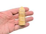 Yellow Calcite obelisk tower crystal from GemstoneGO, showcasing a vibrant yellow mineral with a pointed tip and smooth polished surface.