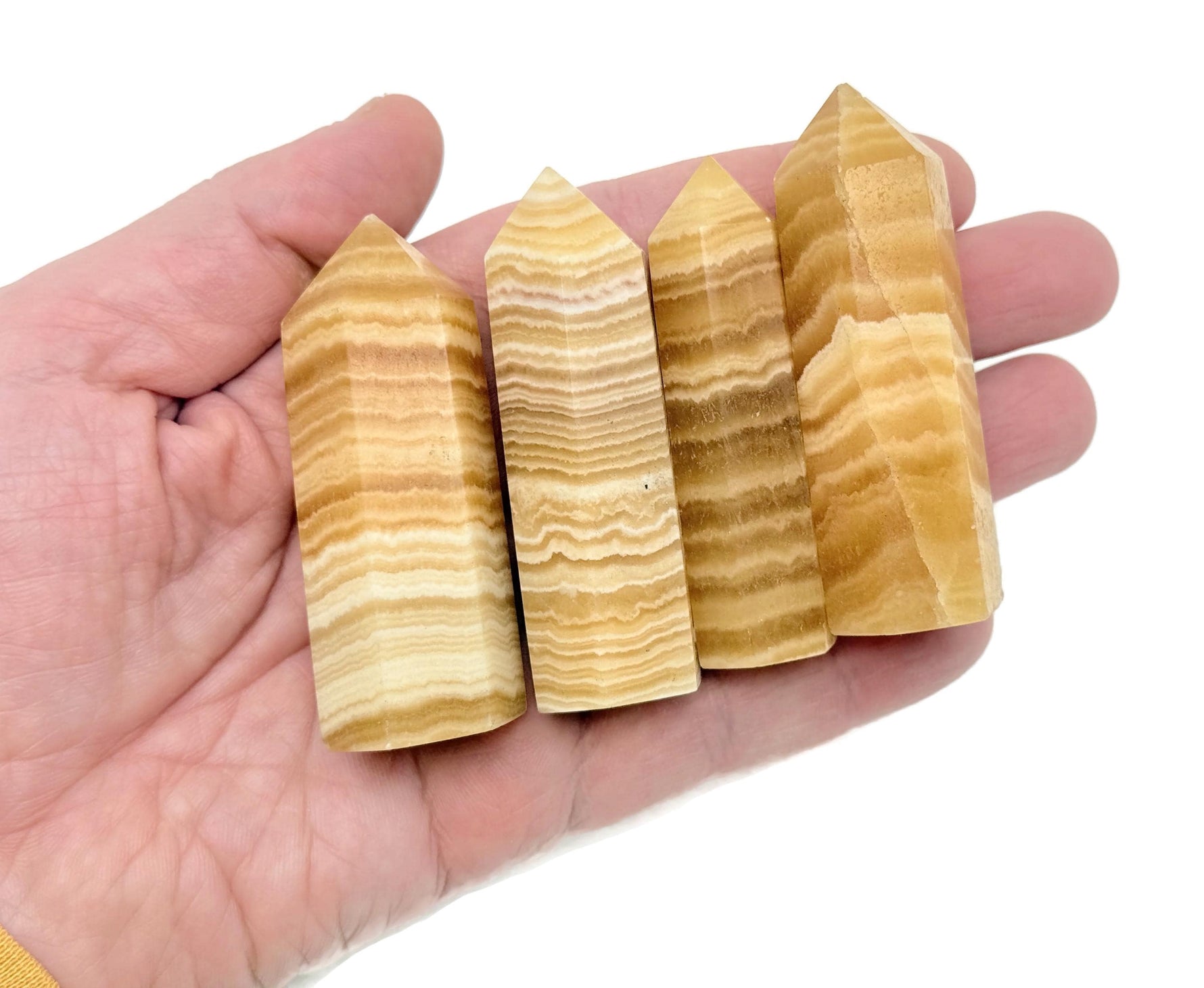 Yellow calcite obelisk tower crystal from GemstoneGO, showing a vibrant yellow mineral with natural crystal formations and smooth polished surfaces.