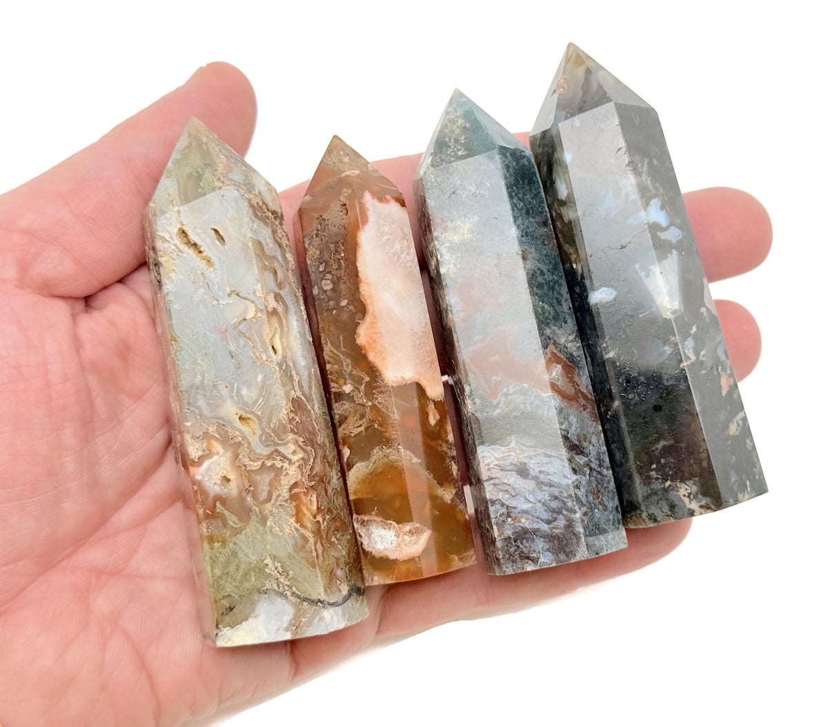 Water Grass Agate obelisk tower crystal from GemstoneGO, featuring green and brown banded patterns on a polished stone.