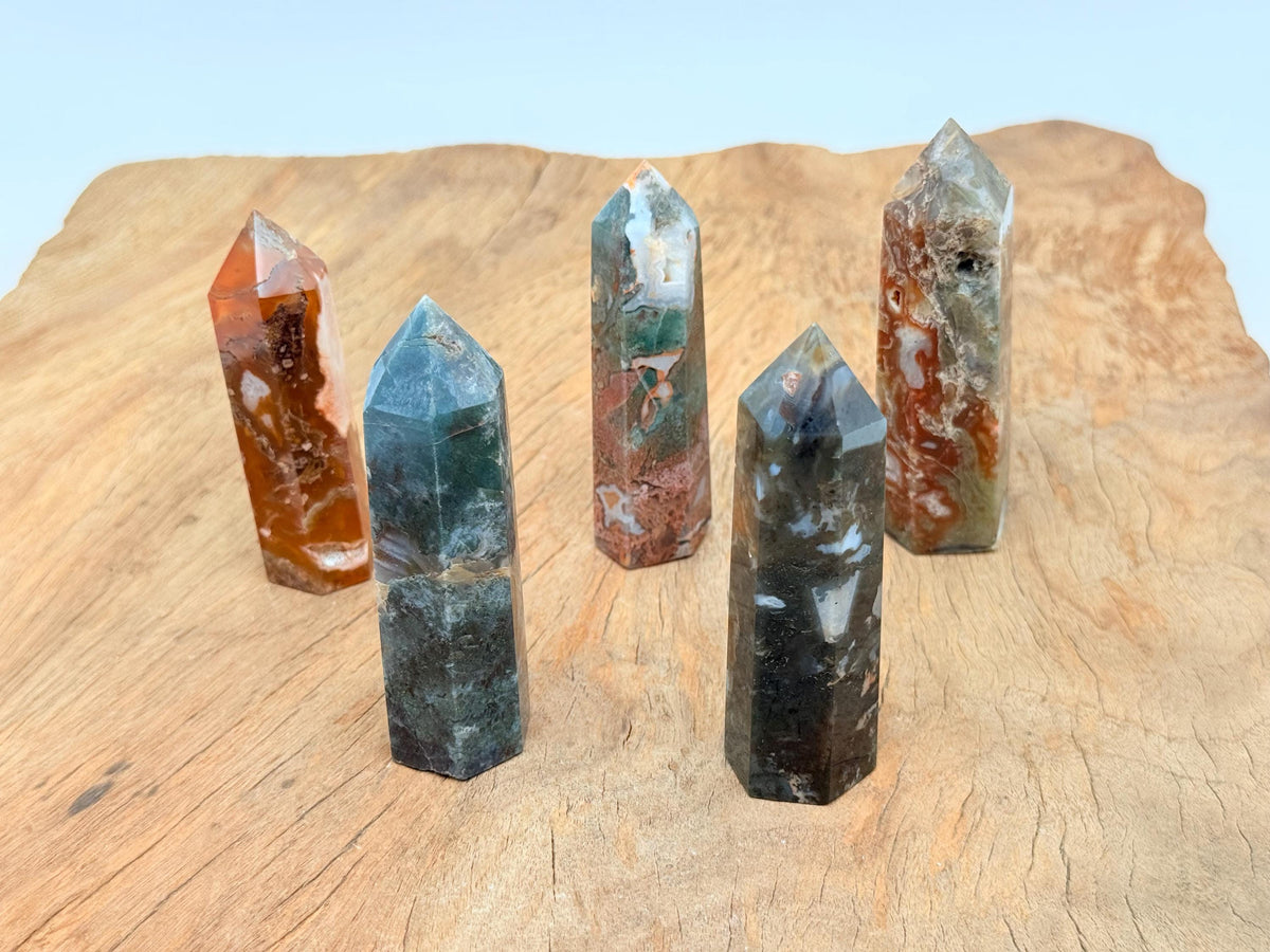 Water Grass Agate obelisk tower crystal from GemstoneGO, featuring intricate green and white banding in a polished stone sculpture.