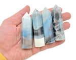 Trolleite obelisk tower crystal from GemstoneGO, polished blue mineral with pointed top and smooth sides.