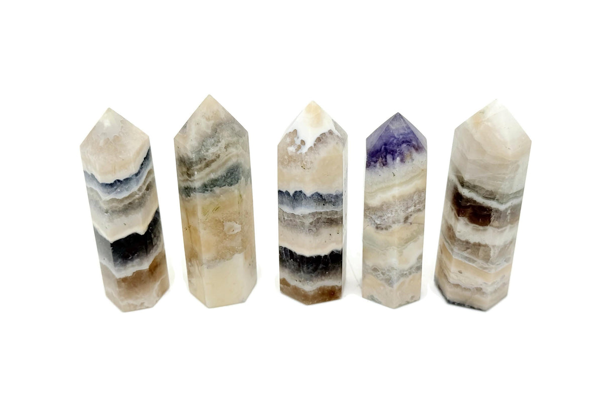 Fluorescent fluorite agate obelisk tower crystal from GemstoneGO showcasing vibrant color and natural stone patterns.