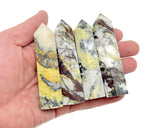 Yellow turquoise obelisk tower crystal from GemstoneGO, featuring a polished yellow turquoise gemstone carved into a tall obelisk shape.