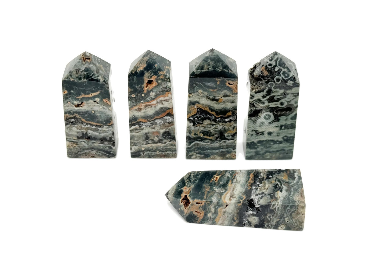 Ocean Jasper obelisk tower crystal by GemstoneGO, featuring vibrant green, orange, and cream patterns in a polished stone display.