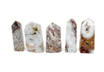 Crazy Lace Agate obelisk tower crystal from GemstoneGO featuring colorful banded patterns and a polished pointed shape.