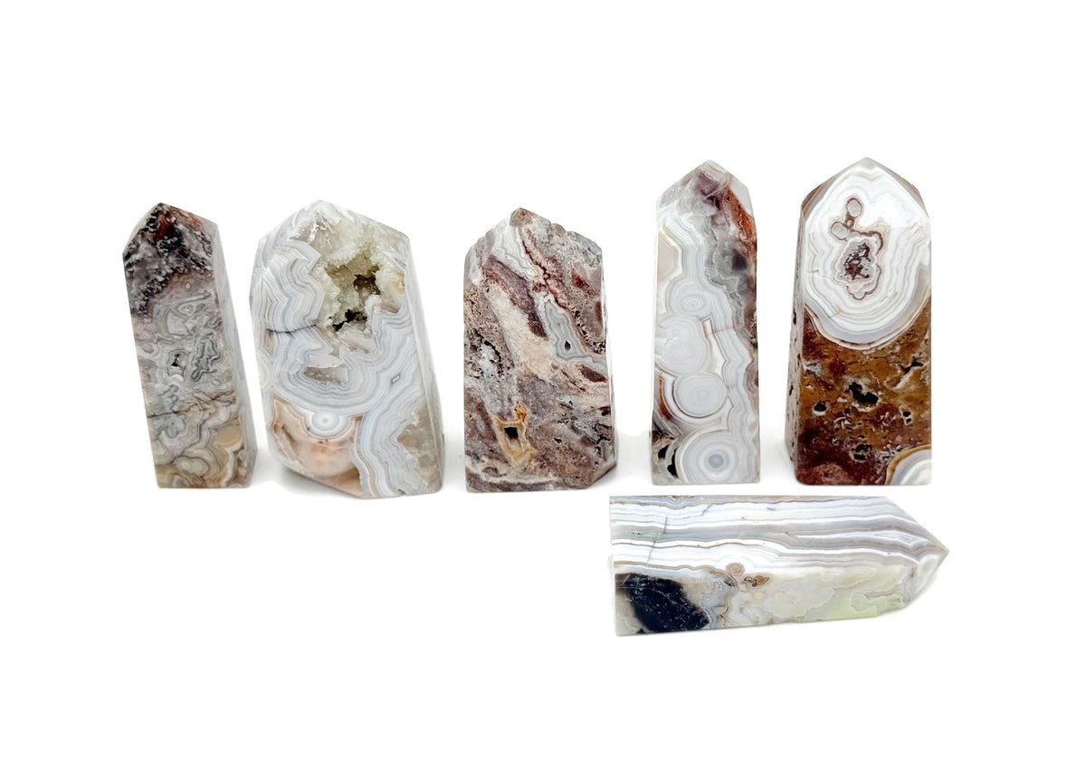 Crazy Lace Agate obelisk tower crystal from GemstoneGO, showcasing vibrant banded patterns and polished stone surface.