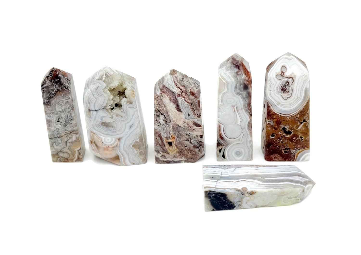 Crazy Lace Agate obelisk tower crystal from GemstoneGO, showcasing vibrant banded patterns and polished stone surface.
