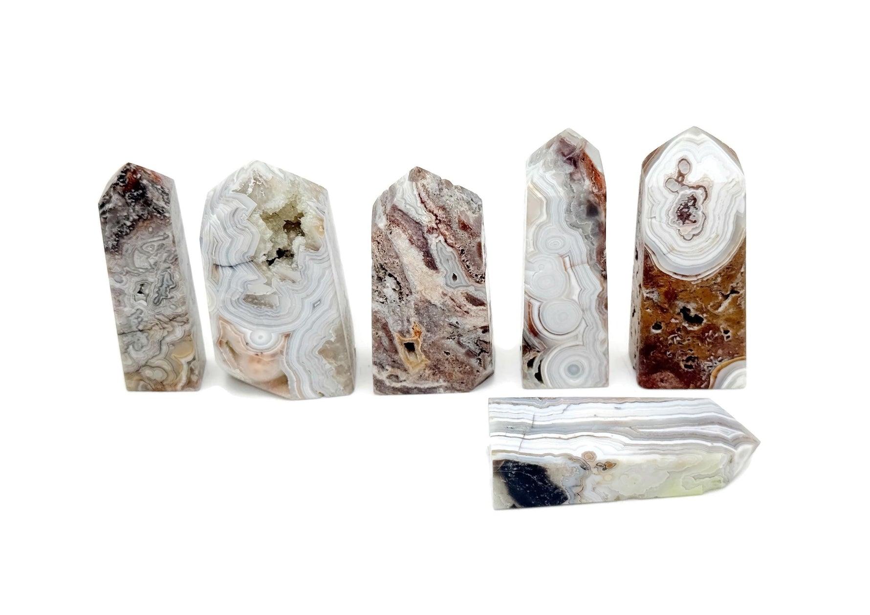 Crazy Lace Agate obelisk tower crystal from GemstoneGO, showcasing vibrant banded patterns and polished stone surface.