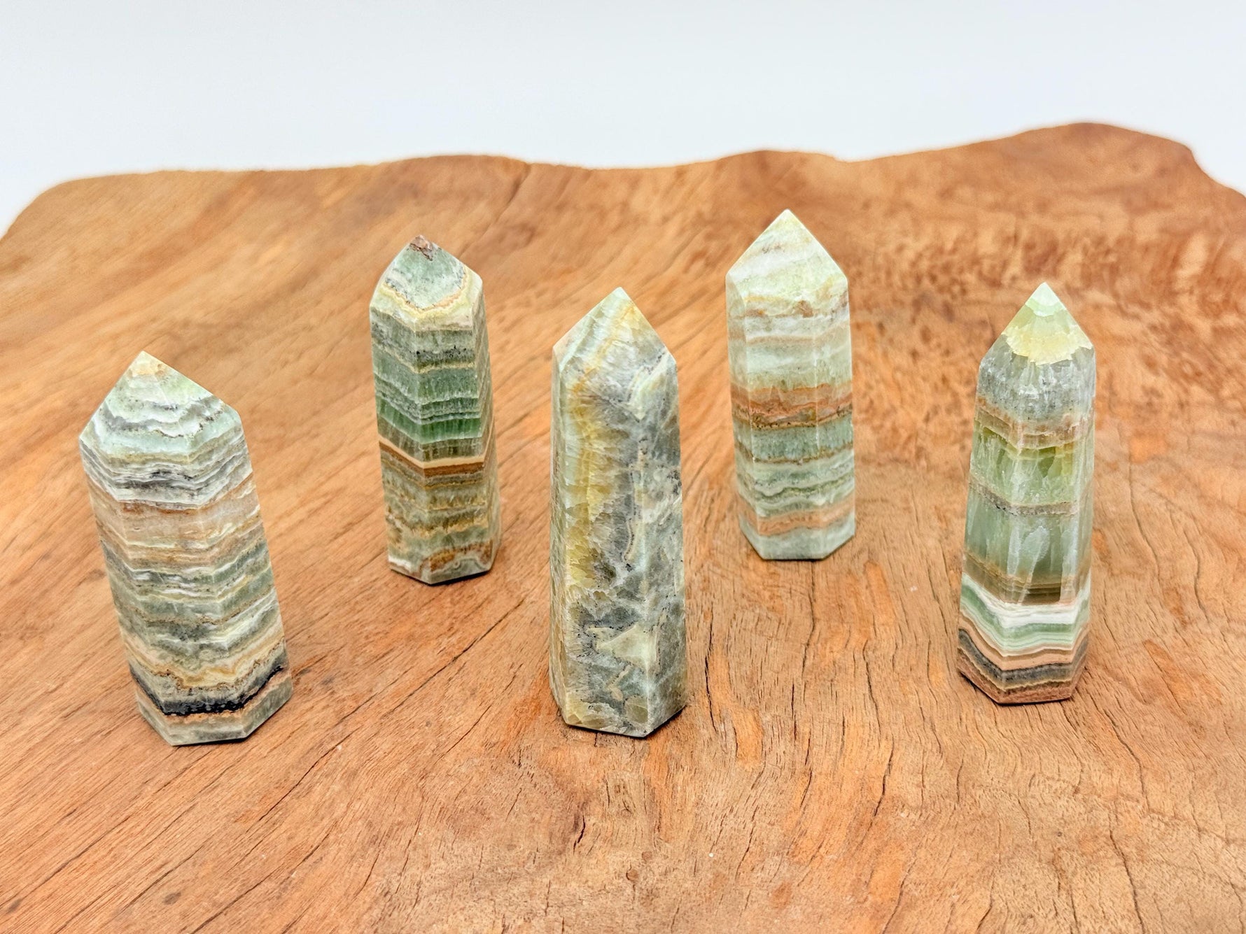 Caribbean Green Calcite obelisk crystal tower from GemstoneGO with smooth, polished surface and vibrant green color.