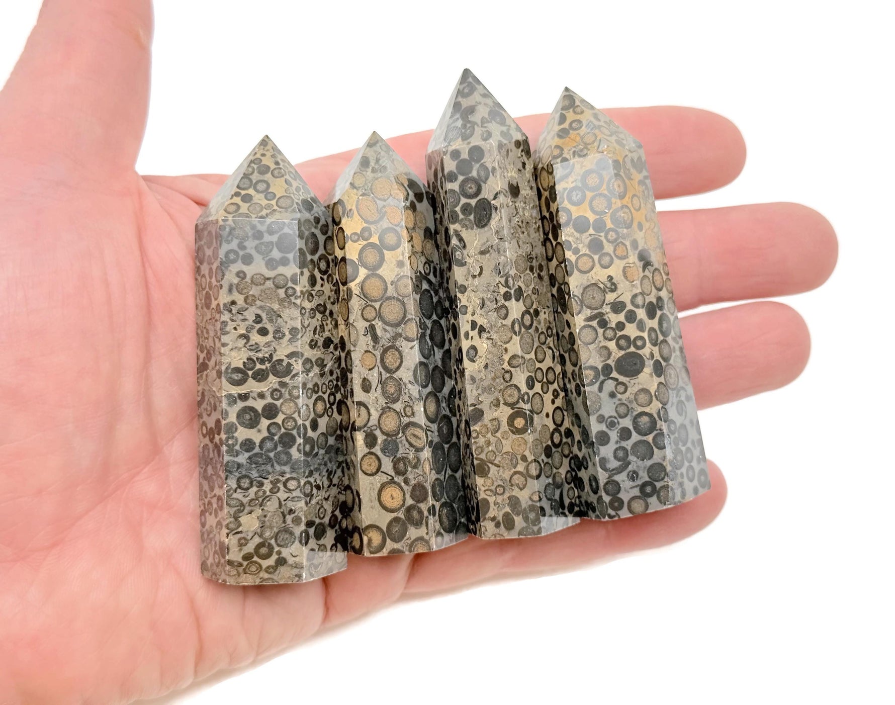 Leopard skin jasper obelisk tower crystal from GemstoneGO, showcasing natural earth-tone patterns and polished stone surface.