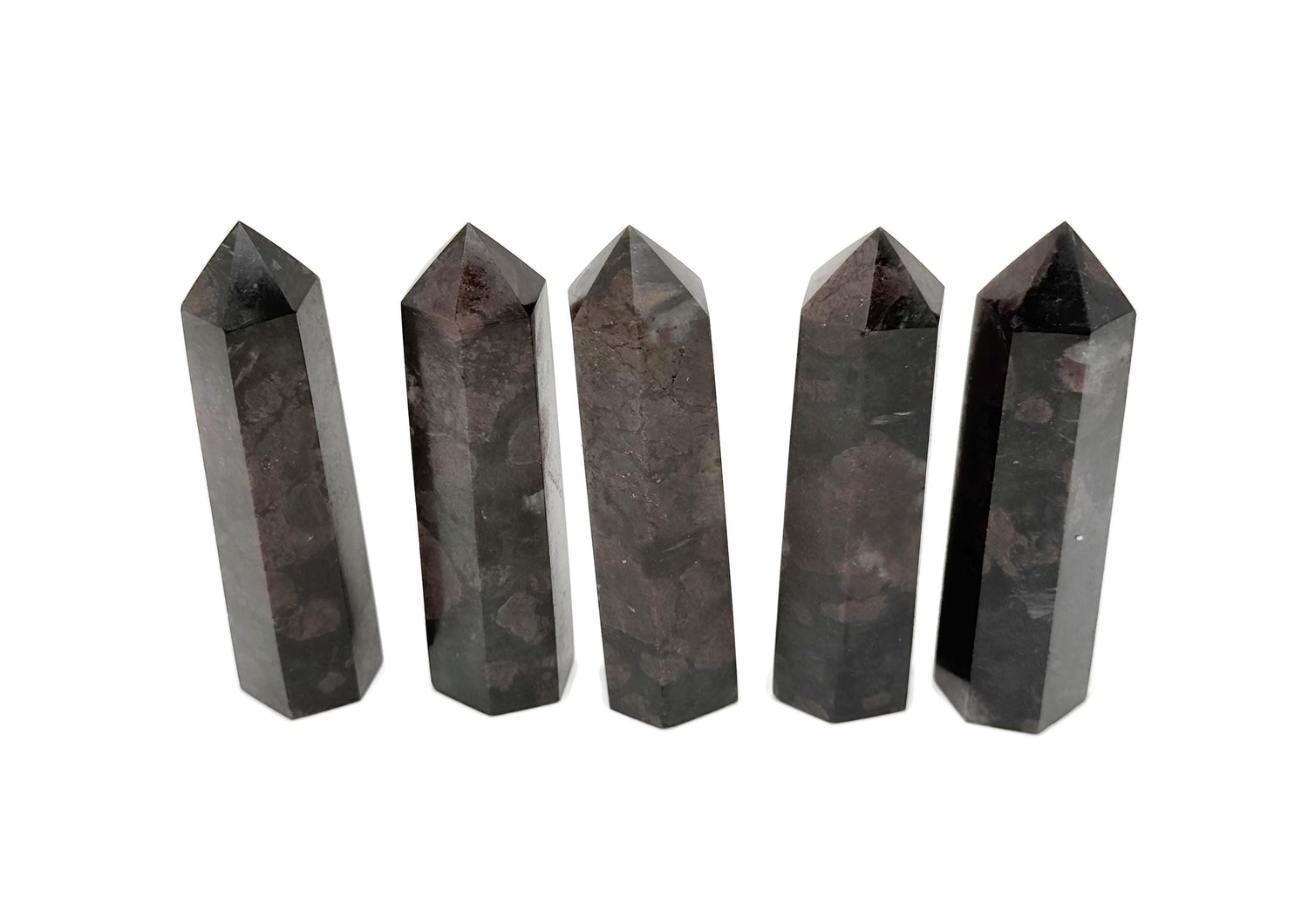 Garnet obelisk tower crystal from GemstoneGO, polished red gemstone with a pointed obelisk shape on a white background.