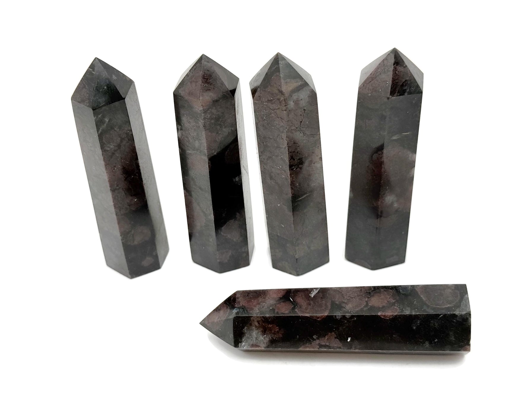 Garnet obelisk tower crystal by GemstoneGO, showcasing a deep red gemstone carved into a tall, pointed obelisk shape.