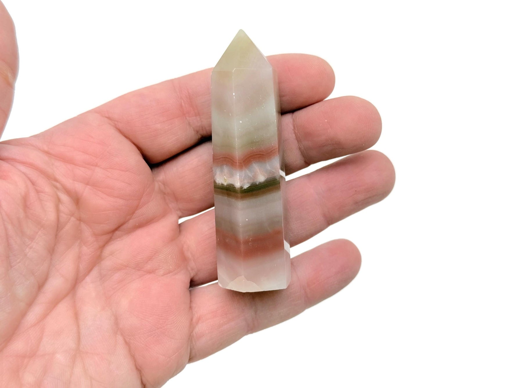 Pink Banded Calcite obelisk tower crystal from GemstoneGO, featuring smooth pink and white banded patterns on a clear base.