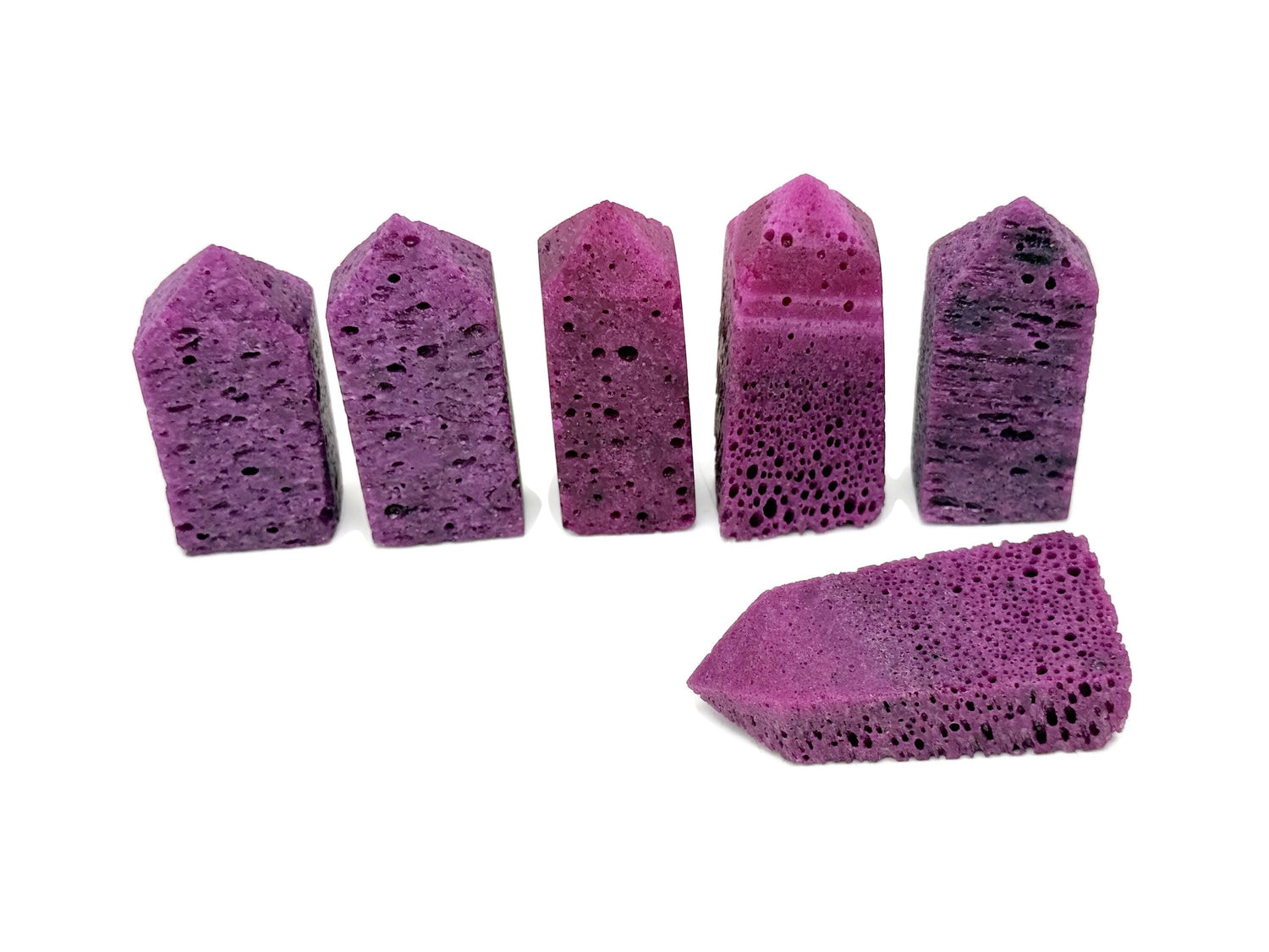 Red corundum obelisk tower crystal from GemstoneGO, showcasing a vibrant, polished gemstone with a pointed obelisk shape.