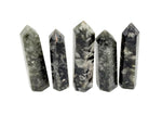 Green Lepidolite obelisk tower crystal from GemstoneGO with a polished, vibrant green and purple hue, showcasing its natural mineral structure.