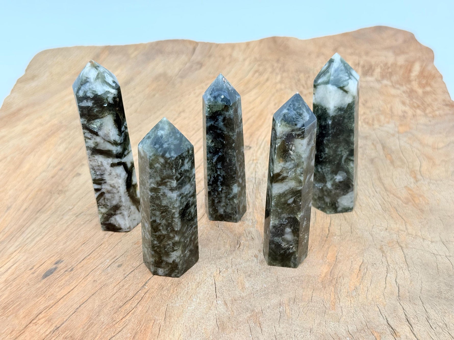 Green Lepidolite obelisk tower crystal from GemstoneGO showing its smooth, polished surface and vibrant green color.