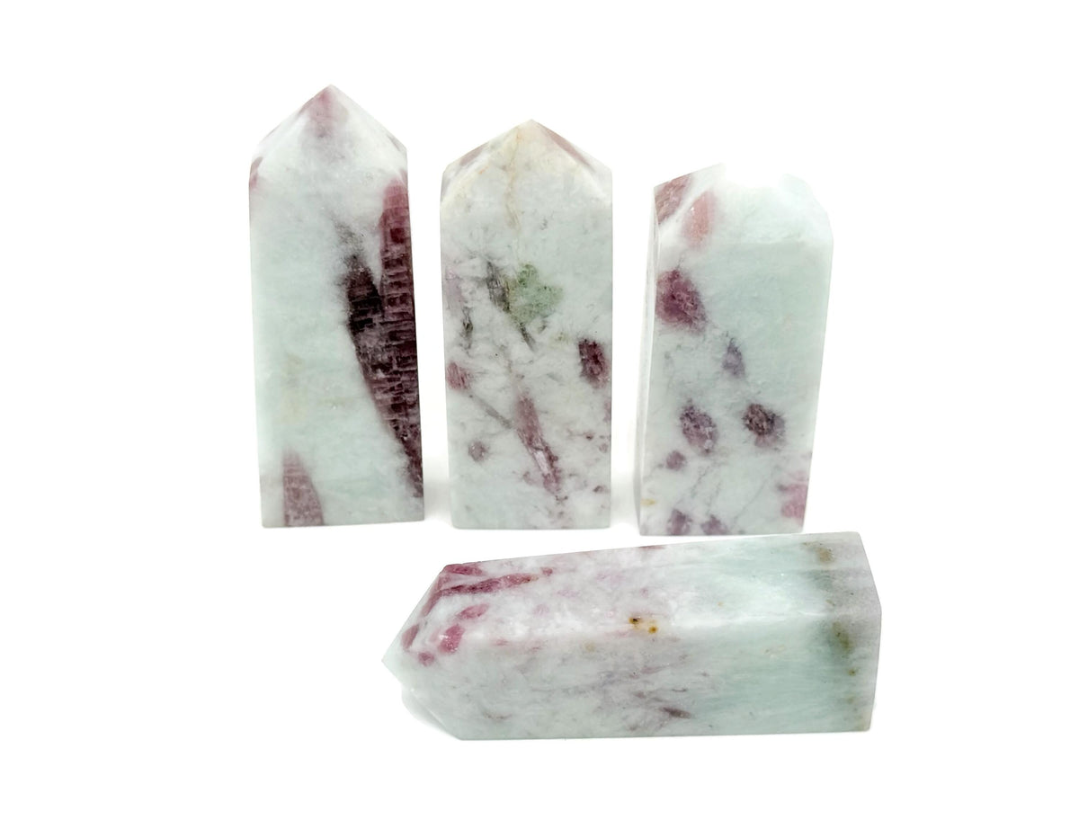 Pink tourmaline obelisk tower crystal from GemstoneGO, showing a polished pink gemstone with natural striations and pointed top.