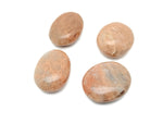 Peach moonstone palm gemstone spa stone from GemstoneGO, smooth polished healing crystal for meditation and relaxation.