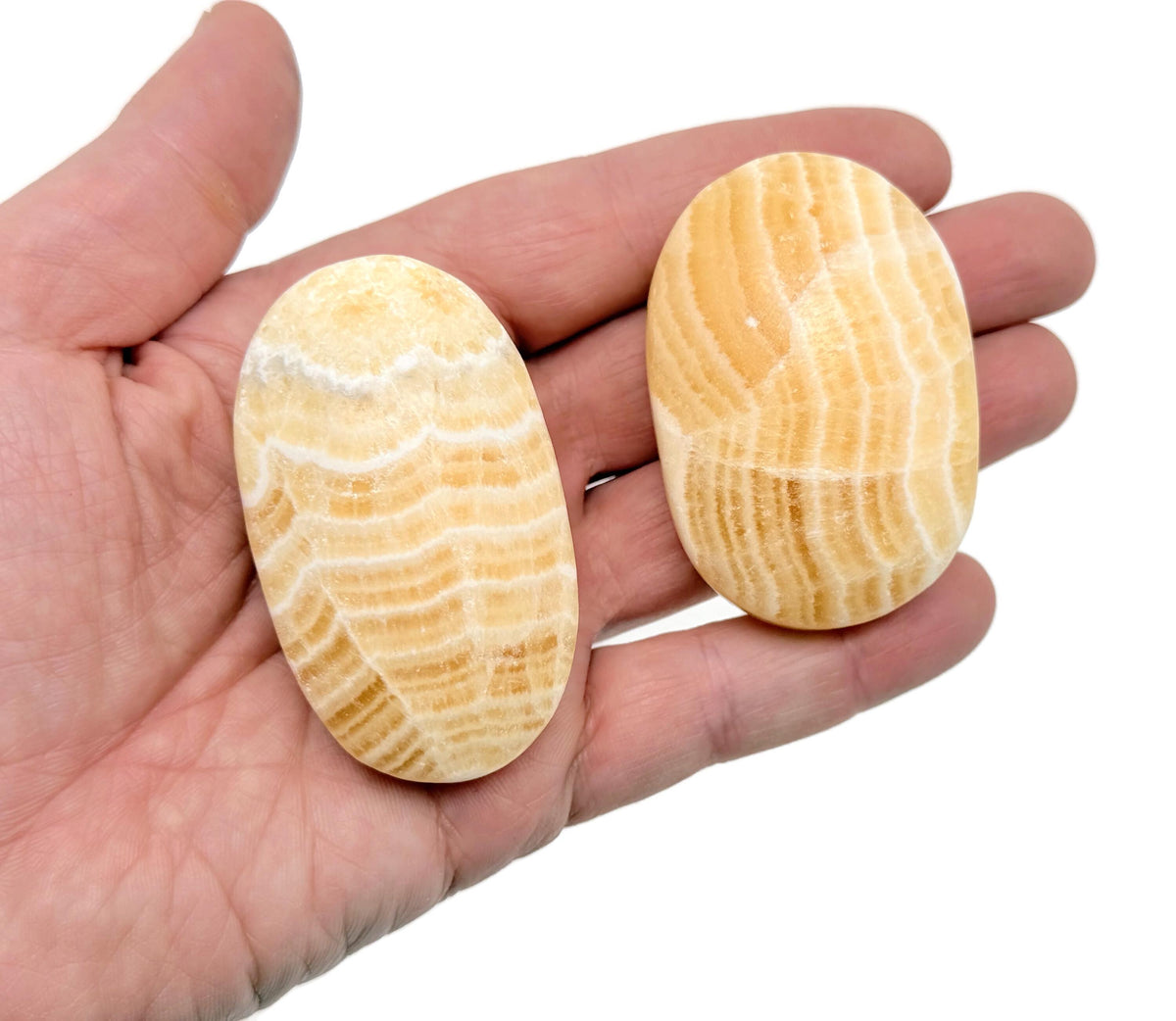 Yellow Calcite palm gemstone spa stone from GemstoneGO, showing smooth, polished yellow calcite with natural texture and rounded shape.