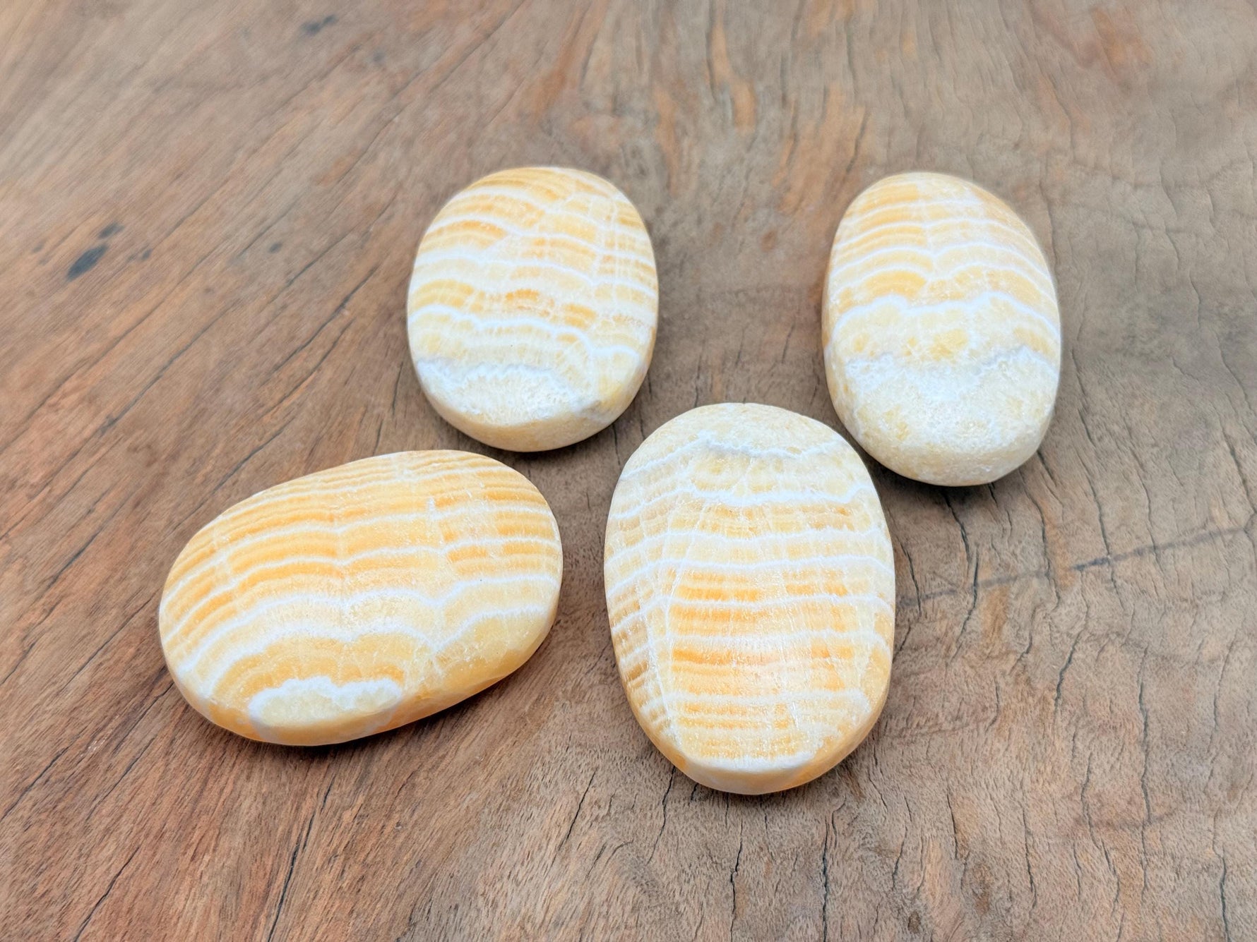 Yellow Calcite palm gemstone spa stone from GemstoneGO, smooth yellow calcite with rounded shape and polished surface.