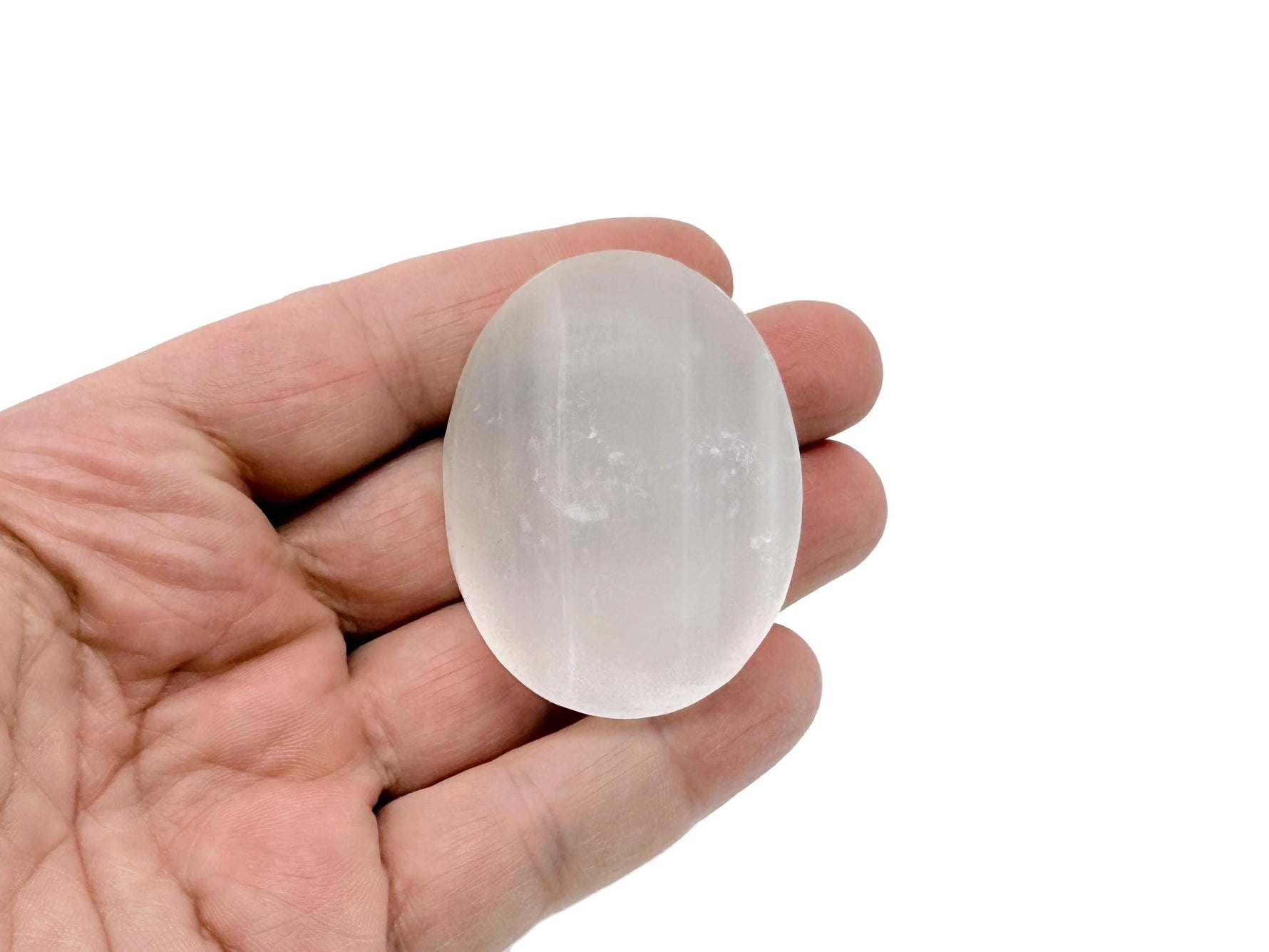 Selenite palm gemstone spa stone, 50mm, smooth and translucent white crystal from GemstoneGO for relaxation and massage.