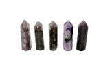 Lepidolite obelisk tower crystal from GemstoneGO, showcasing purple and pink hues with smooth polished surfaces and natural mineral patterns.