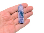 Lepidolite obelisk tower crystal from GemstoneGO, showcasing purple and lavender mineral with natural striations and polished surface.