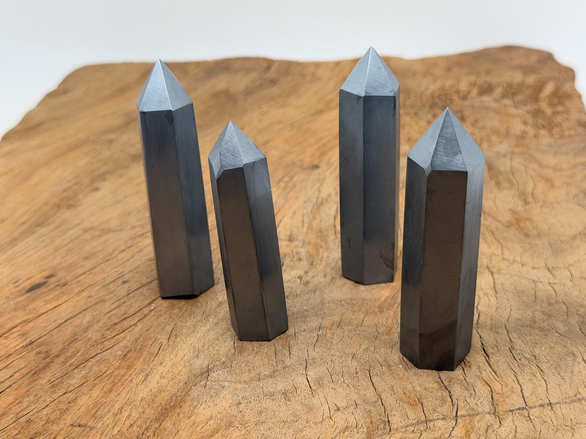 Terahertz Obelisk Tower Crystal by GemstoneGO, featuring a sleek, polished gemstone obelisk with intricate natural stone patterns.
