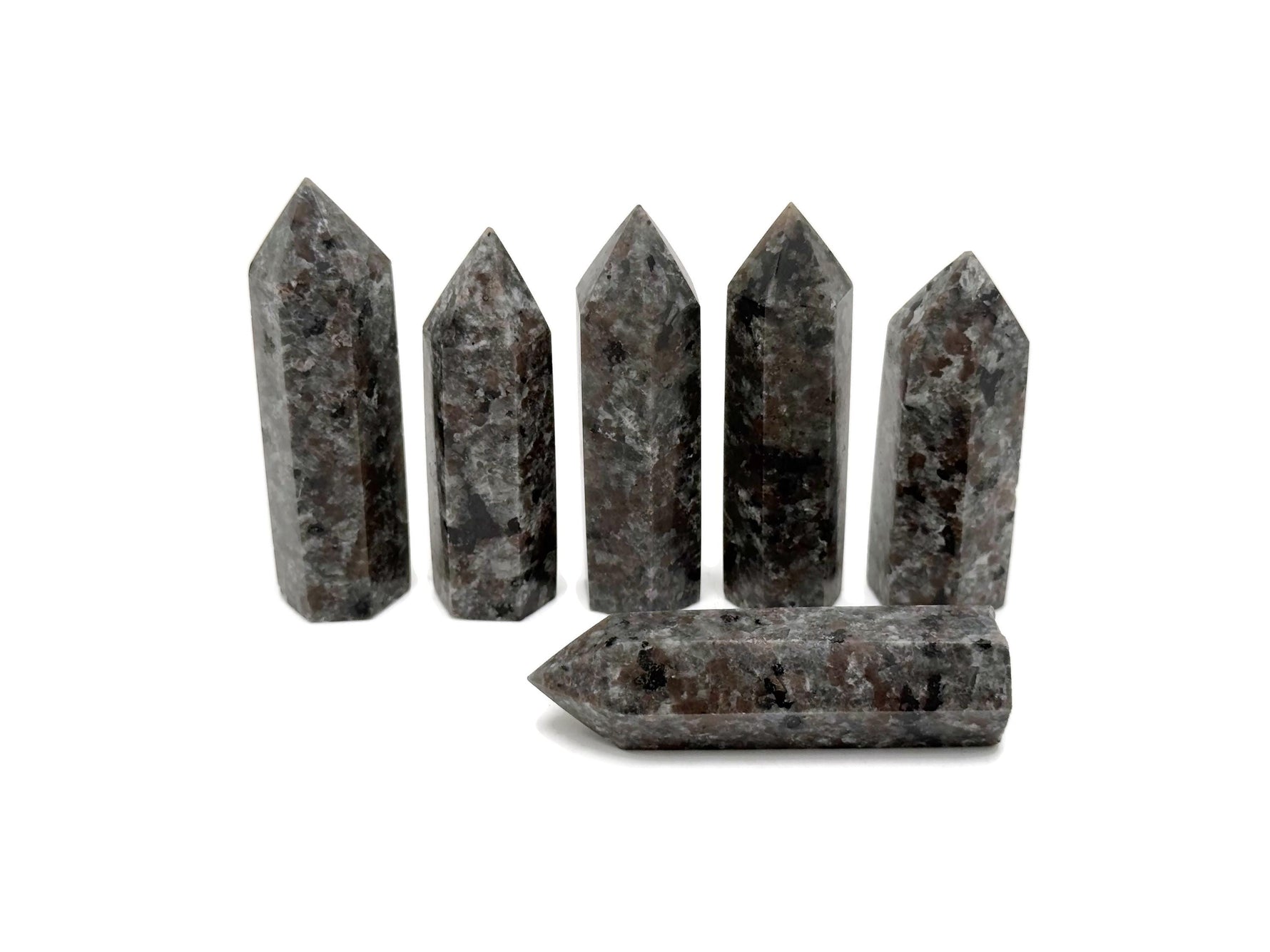 Yooperlite obelisk tower crystal with glowing fluorescent sodalite stone, showcasing vibrant blue and purple hues under UV light.
