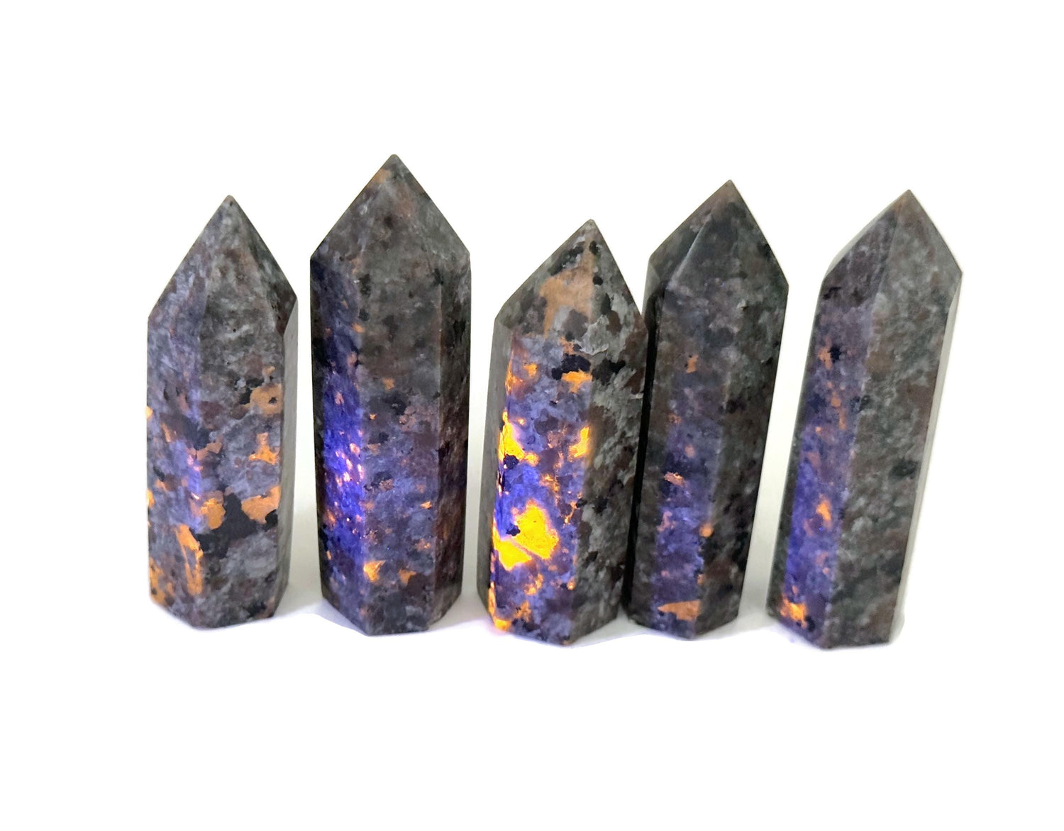 Yooperlite obelisk tower crystal with fluorescent sodalite stone, showcasing vibrant blue and purple hues under UV light.