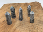 Picasso Jasper obelisk tower crystal from GemstoneGO showcasing a polished, multicolored gemstone obelisk with intricate patterns.