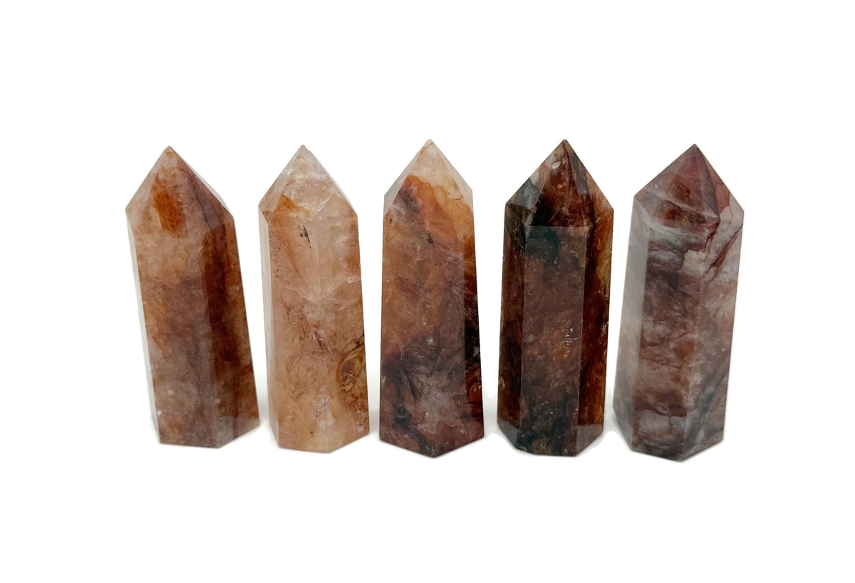 Red Hematoid Quartz Fire Quartz obelisk tower crystal from GemstoneGO, showcasing a striking red and translucent stone with natural crystal facets.