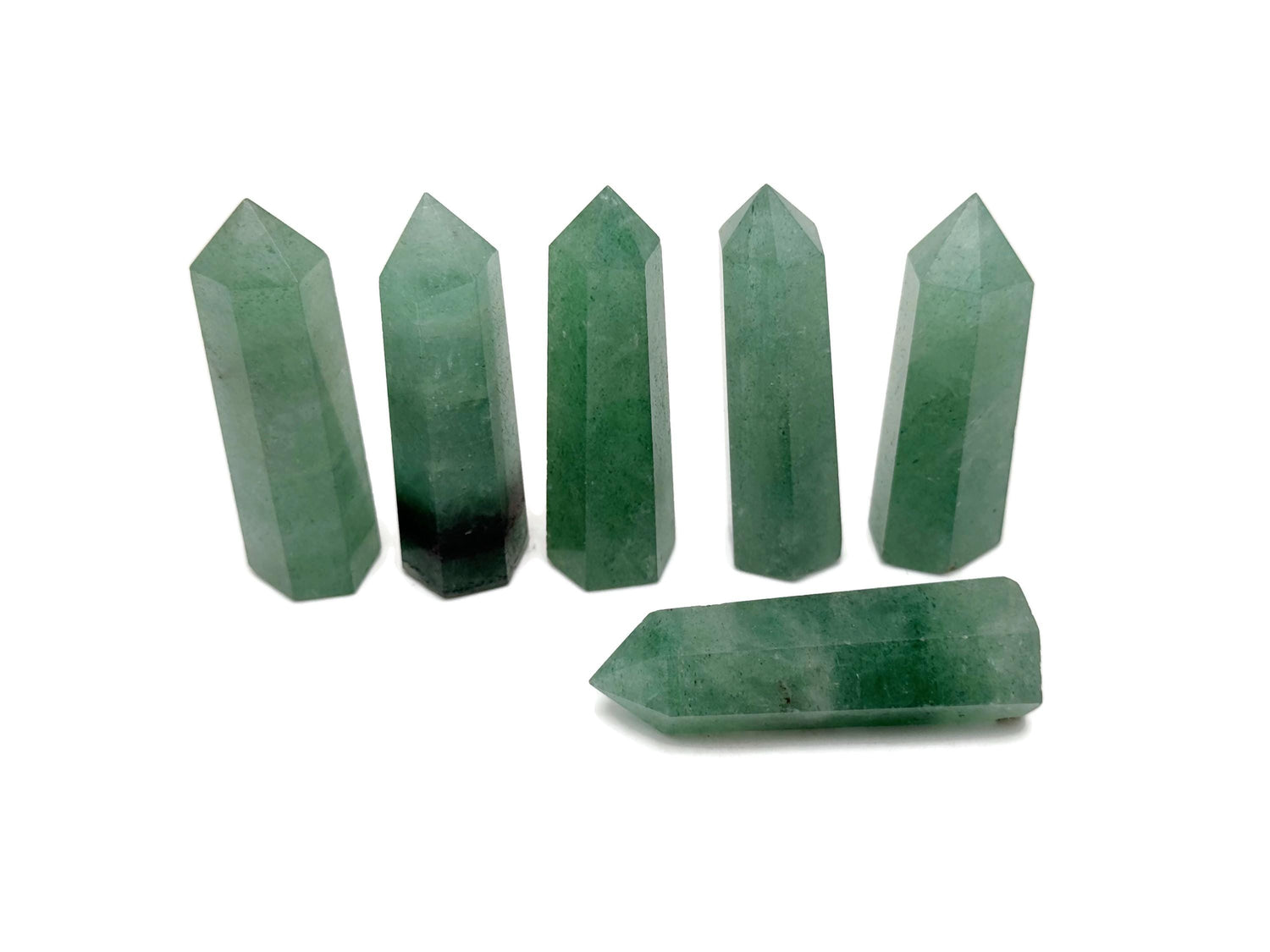 Green strawberry quartz obelisk tower crystal by GemstoneGO, featuring a polished green stone with natural crystal facets.