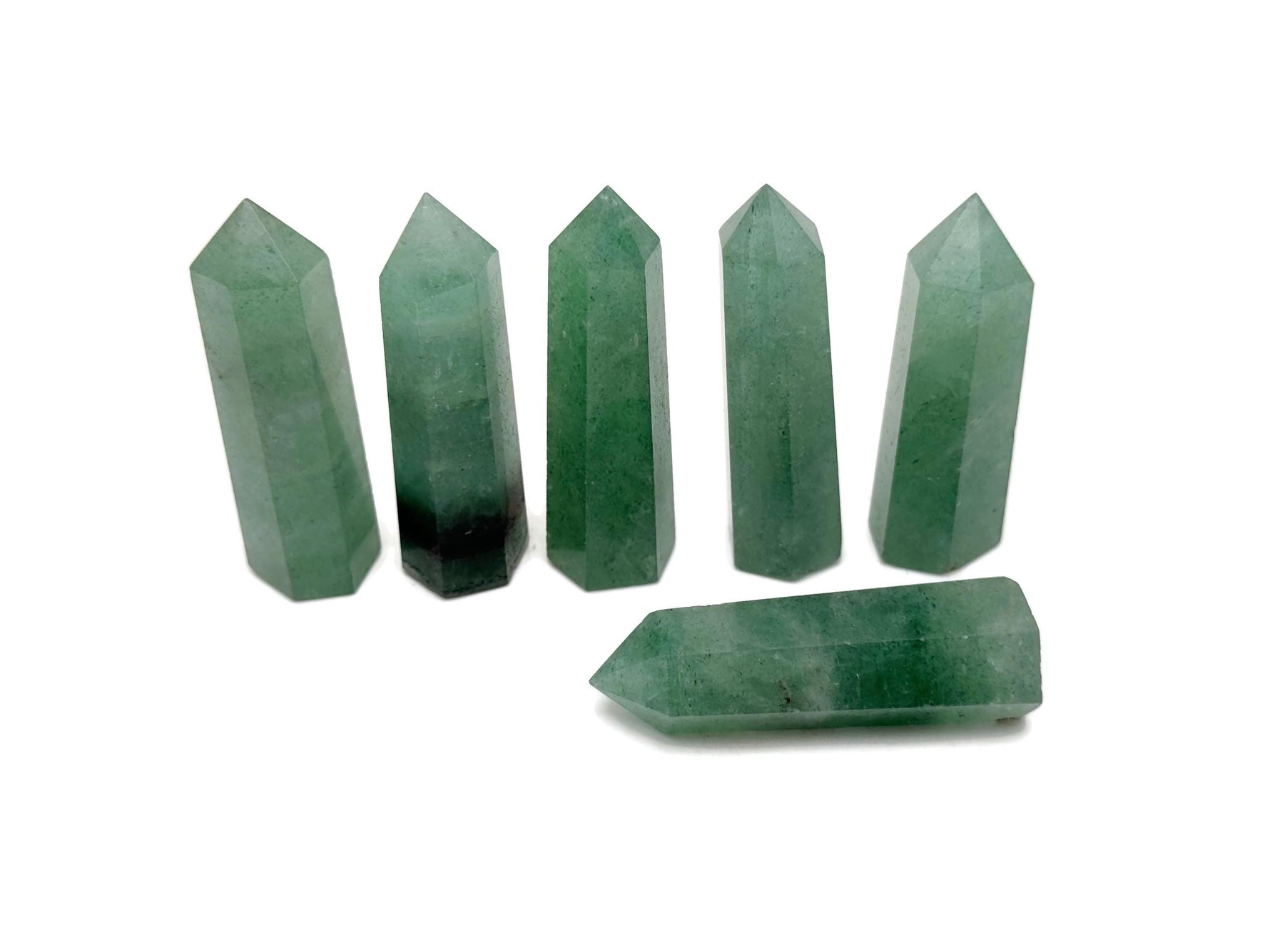 Green strawberry quartz obelisk tower crystal by GemstoneGO, featuring a polished green stone with natural crystal facets.