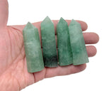 Green strawberry quartz obelisk tower crystal with polished facets and natural gemstone texture from GemstoneGO.