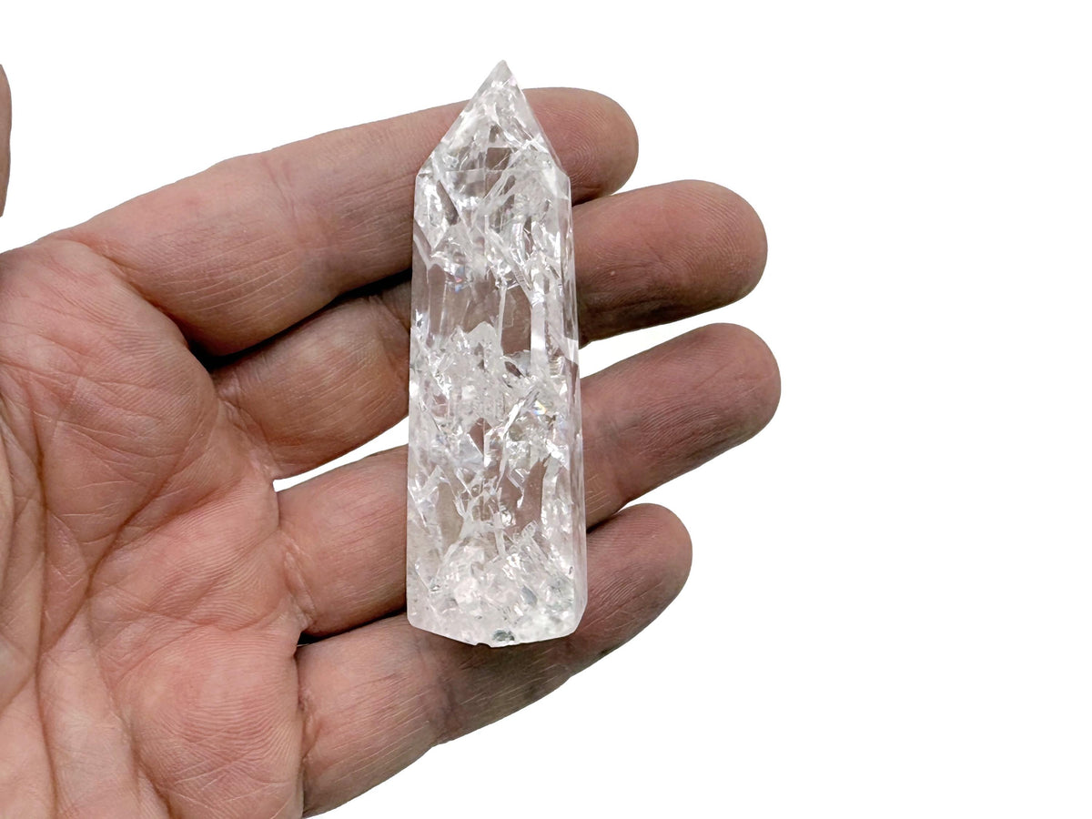 Cracked clear quartz obelisk tower crystal by GemstoneGO, featuring a tall, pointed quartz crystal with natural crack patterns.