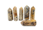 Crazy Lace Agate obelisk tower crystal from GemstoneGO showcasing vibrant, intricate patterns and polished stone surface.