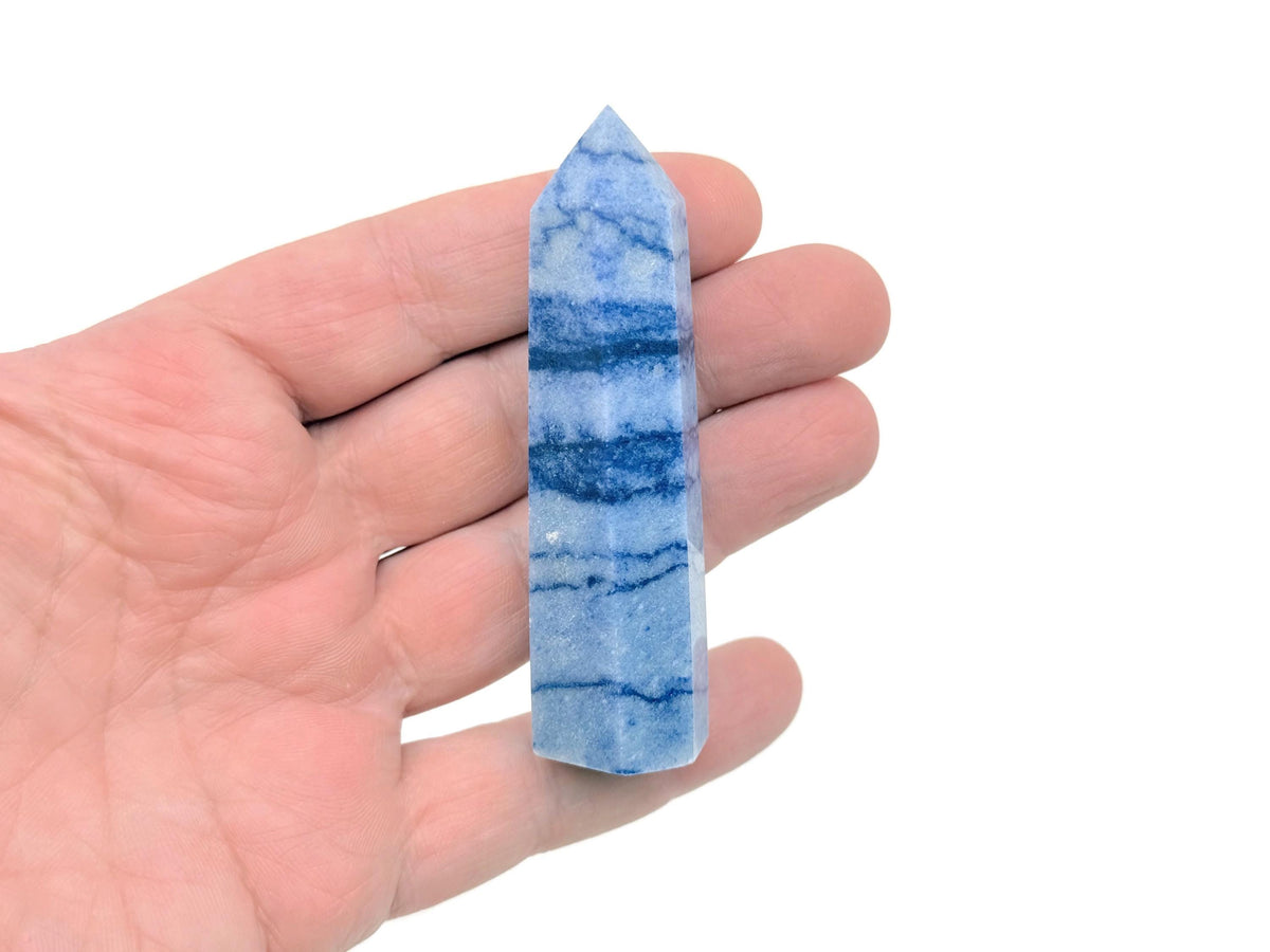 Blue aventurine obelisk tower crystal from GemstoneGO showcasing a polished, deep blue gemstone with natural streaks and facets.