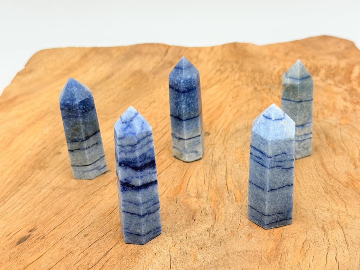 Blue aventurine obelisk tower crystal from GemstoneGO, showcasing a polished blue gemstone with natural veining and a pointed top.