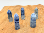 Blue aventurine obelisk tower crystal from GemstoneGO, showcasing a polished blue gemstone with natural veining and a pointed top.
