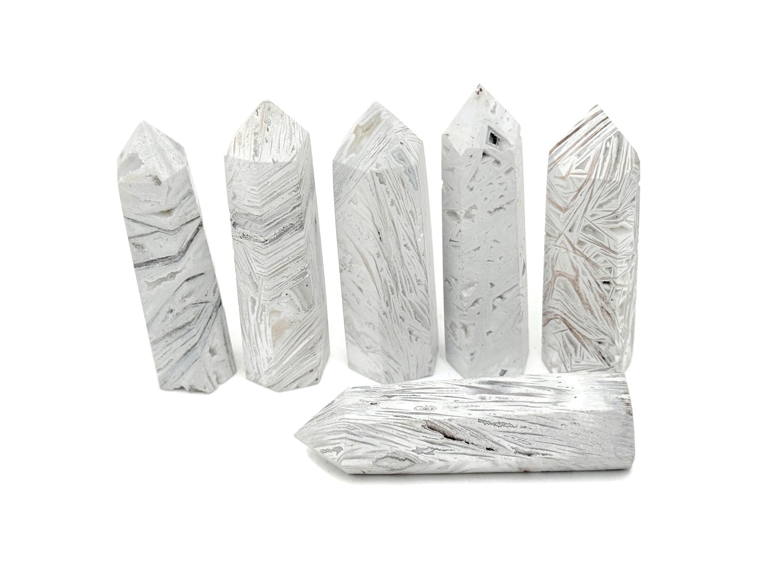 Mexican White Agate obelisk tower crystal by GemstoneGO, showcasing smooth polished surface and natural white veining.