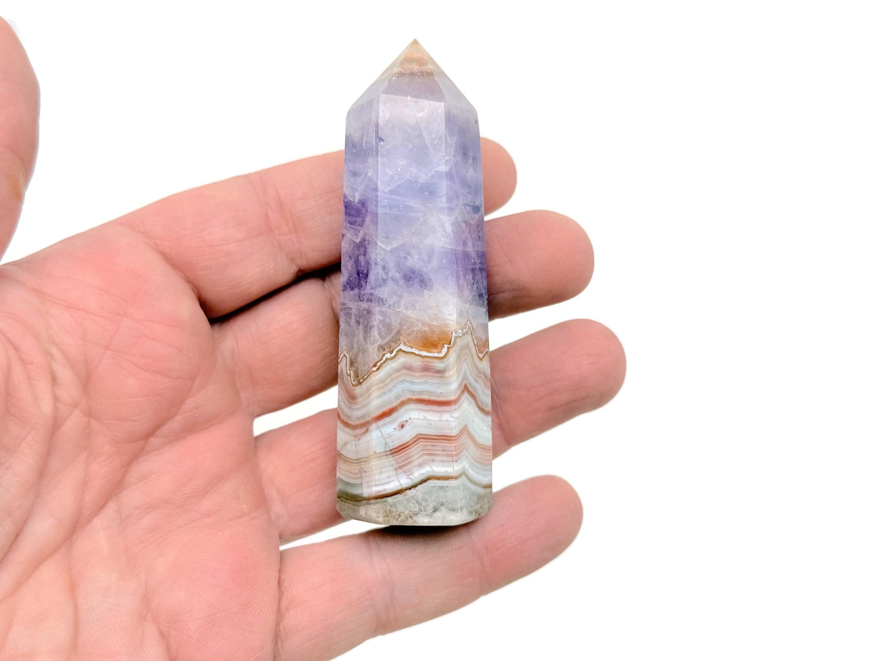 Amethyst Crazy Lace Agate obelisk tower crystal from GemstoneGO, showcasing purple and patterned banding with a pointed top.