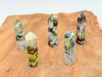 Yellow turquoise obelisk tower crystal from GemstoneGO, showcasing a polished yellow turquoise gemstone carved into a tall obelisk shape.