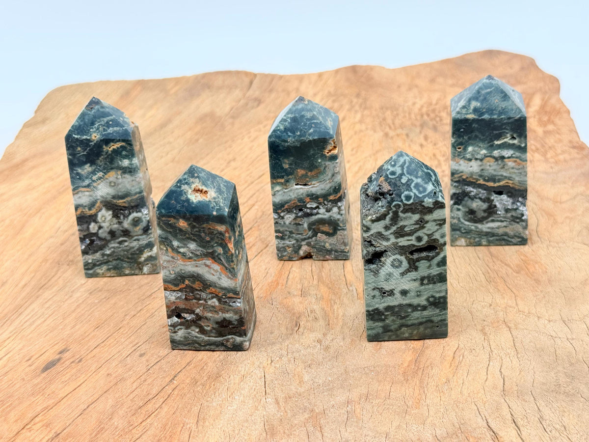 Ocean Jasper obelisk tower crystal by GemstoneGO, showcasing a colorful, polished gemstone with natural patterns and a pointed top.