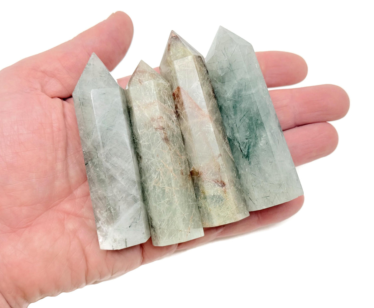Green rutilated quartz obelisk tower crystal from GemstoneGO, featuring a polished green quartz stone with needle-like rutile inclusions.