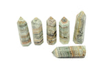 Caribbean Green Calcite obelisk tower crystal from GemstoneGO, showcasing a vibrant green mineral with smooth polished surfaces.